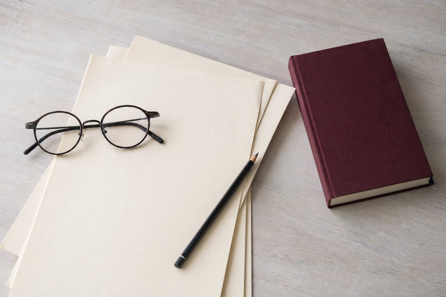 Paper and reading glasses on a quiet desk